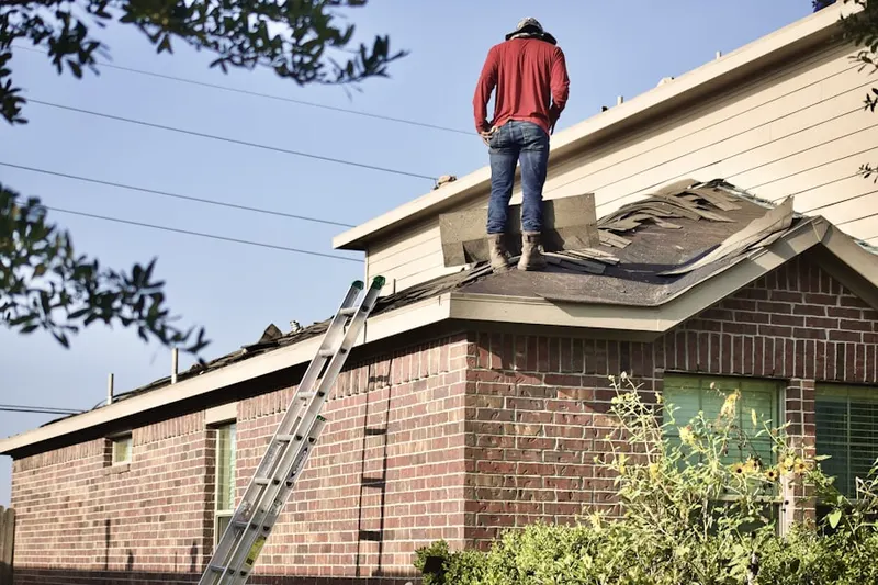 Professional roofer working on a residential roof in McHenry